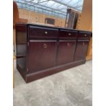 A STAG MINSTREL SIDEBOARD ENCLOSING THREE DRAWERS AND THREE CUPBOARDS, 54" WIDE