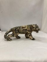 A MODEL OF A LARGE CAT WITH A PATCHWORK SAFARI DESIGN, HEIGHT 15CM, LENGTH 30CM