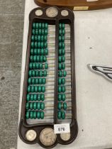 A CHINESE ABACUS WITH MALACHITE COUNTERS AND SILVER COINS