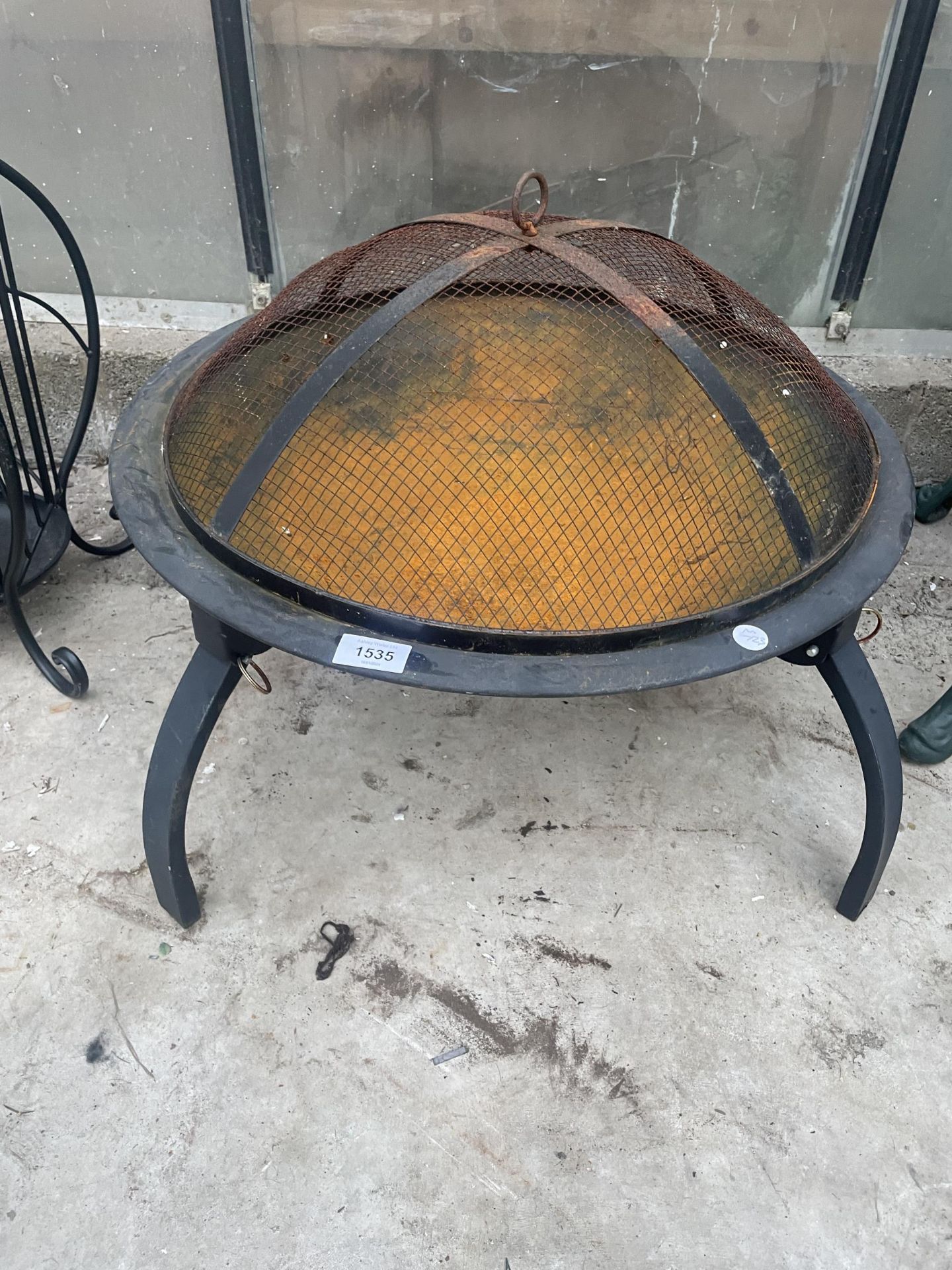 A LOW METAL FOUR LEGGED FIRE PIT