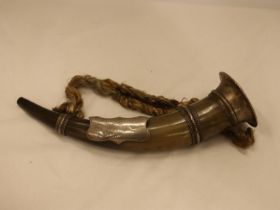 AN ANIMAL HORN WITH WHITE METAL PLAQUE AND DECORATION