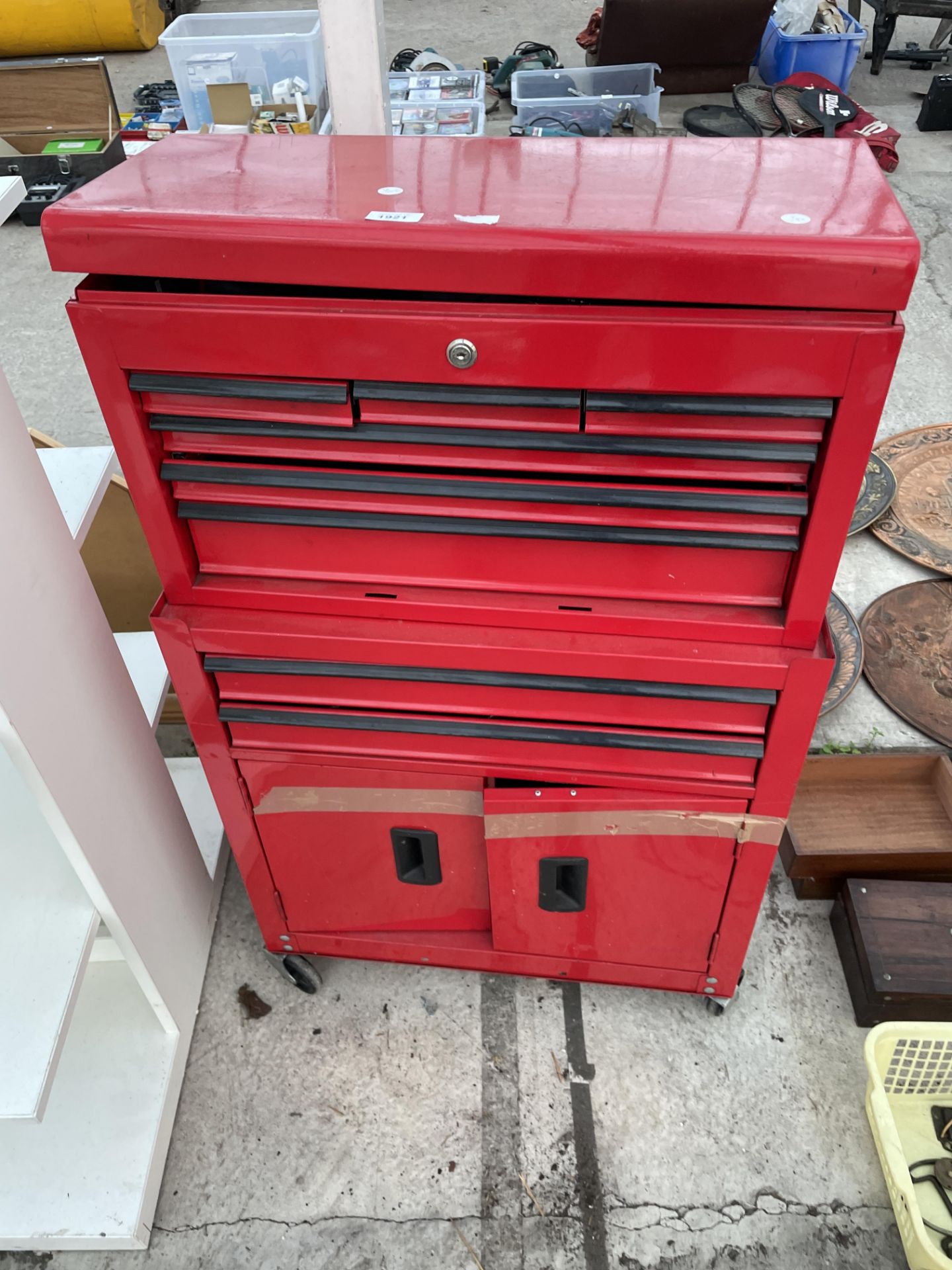 A FOUR WHEELED METAL WORKSHOP TOOL CHEST WITH MULTIPLE DRAWERS AND LOWER CUPBOARD