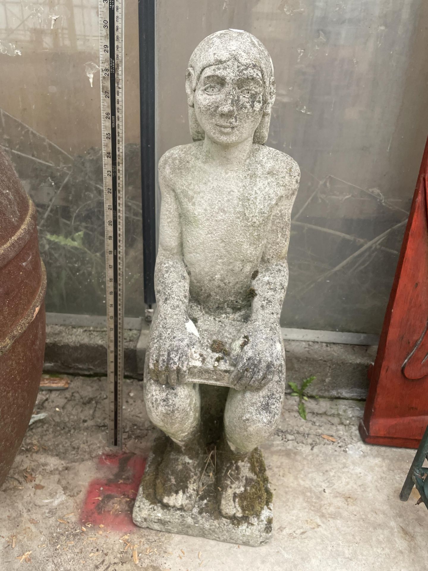 A RECONSTITUTED STONE FIGURE OF A SEATED MALE (H:77CM)