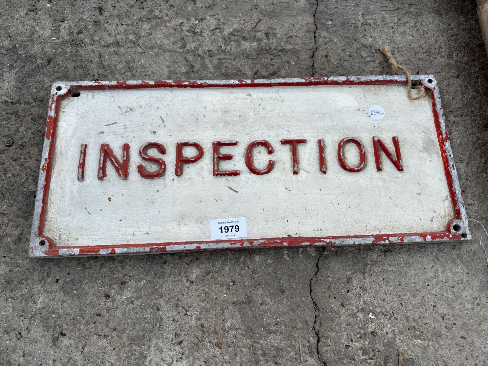 A VINTAGE CAST METAL 'INSPECTION' SIGN