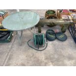AN ASSORTMENT OF ITEMS TO INCLUDE A HOSE PIPE, TABLE AND PLANT PROTECTORS ETC