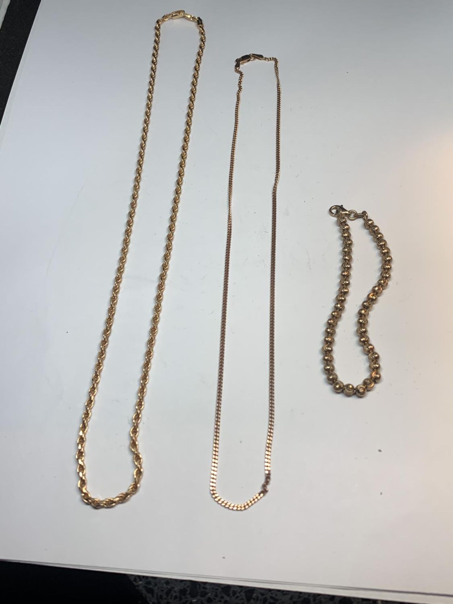 THREE ITEMS OF SILVER GILT JEWELLERY TO INCLUDE A BRACELET AND TWO NECKLACES