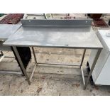 A TALL STAINLESS STEEL INDUSTRIAL KITCHEN WORK BENCH