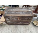 A VINTAGE DOMED TRAVEL TRUNK WITH METAL BANDING