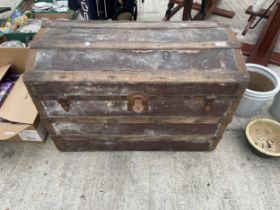 A VINTAGE DOMED TRAVEL TRUNK WITH METAL BANDING
