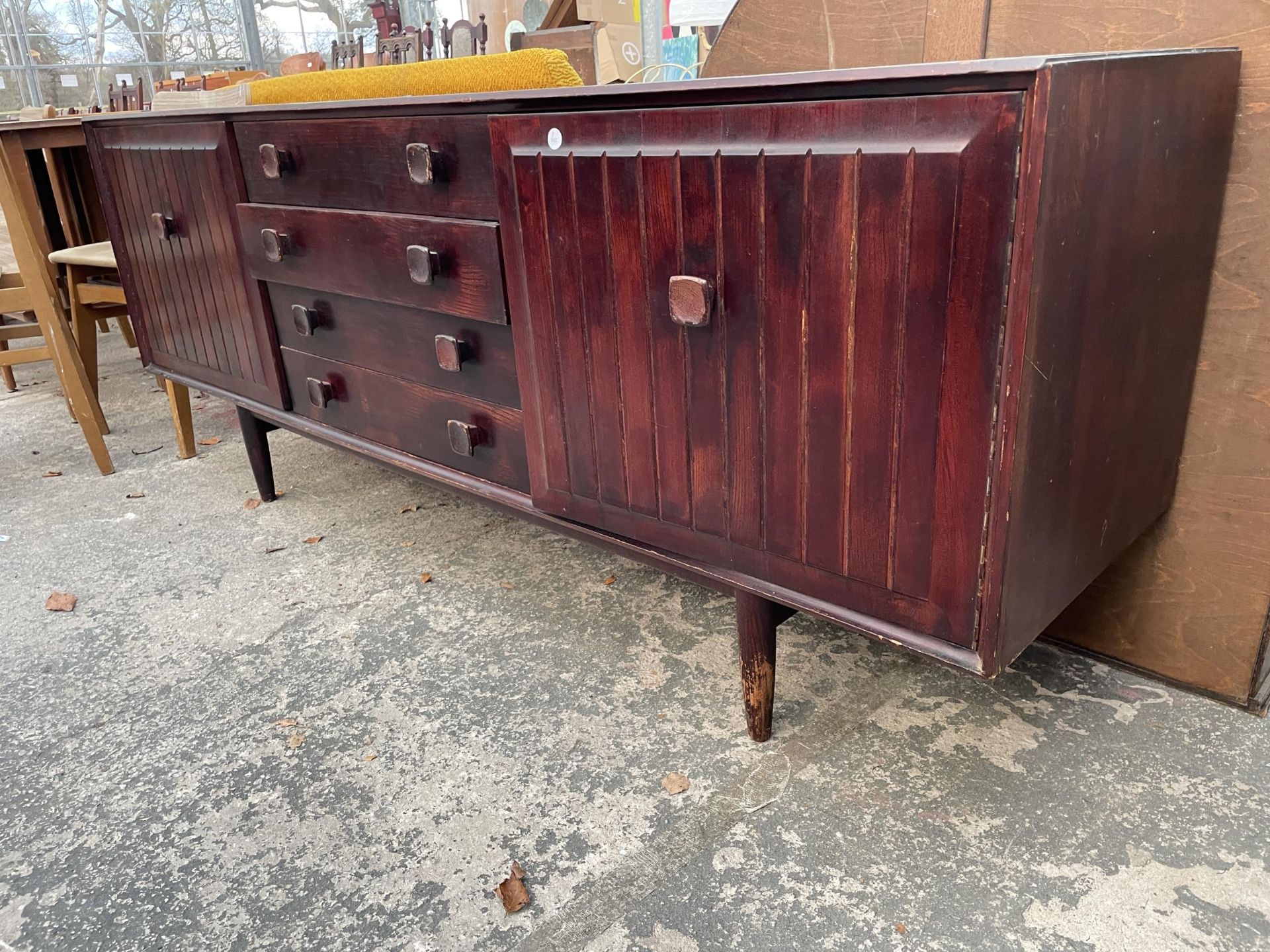 A RETRO 'ENSIGN' STAINED ELM SIDEBOARD ENCLOSING FOUR DRAWERS AND TWO CUPBOARDS, 70" WIDE - Image 2 of 2