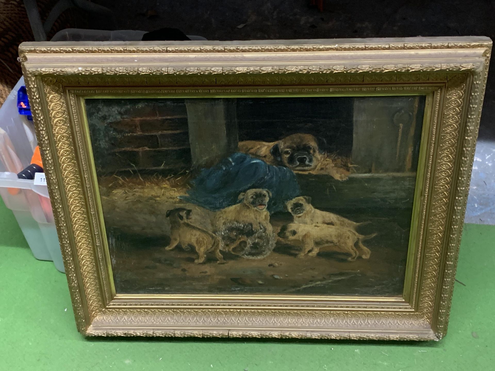 A FRAMED OIL ON CANVAS OF A MOTHER AND HER PUPPIES
