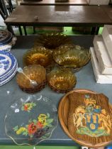 AN AMBER GLASS SERVING SET TOGETHER WITH A WOODEN SHIELD AND CHOPPING BOARD