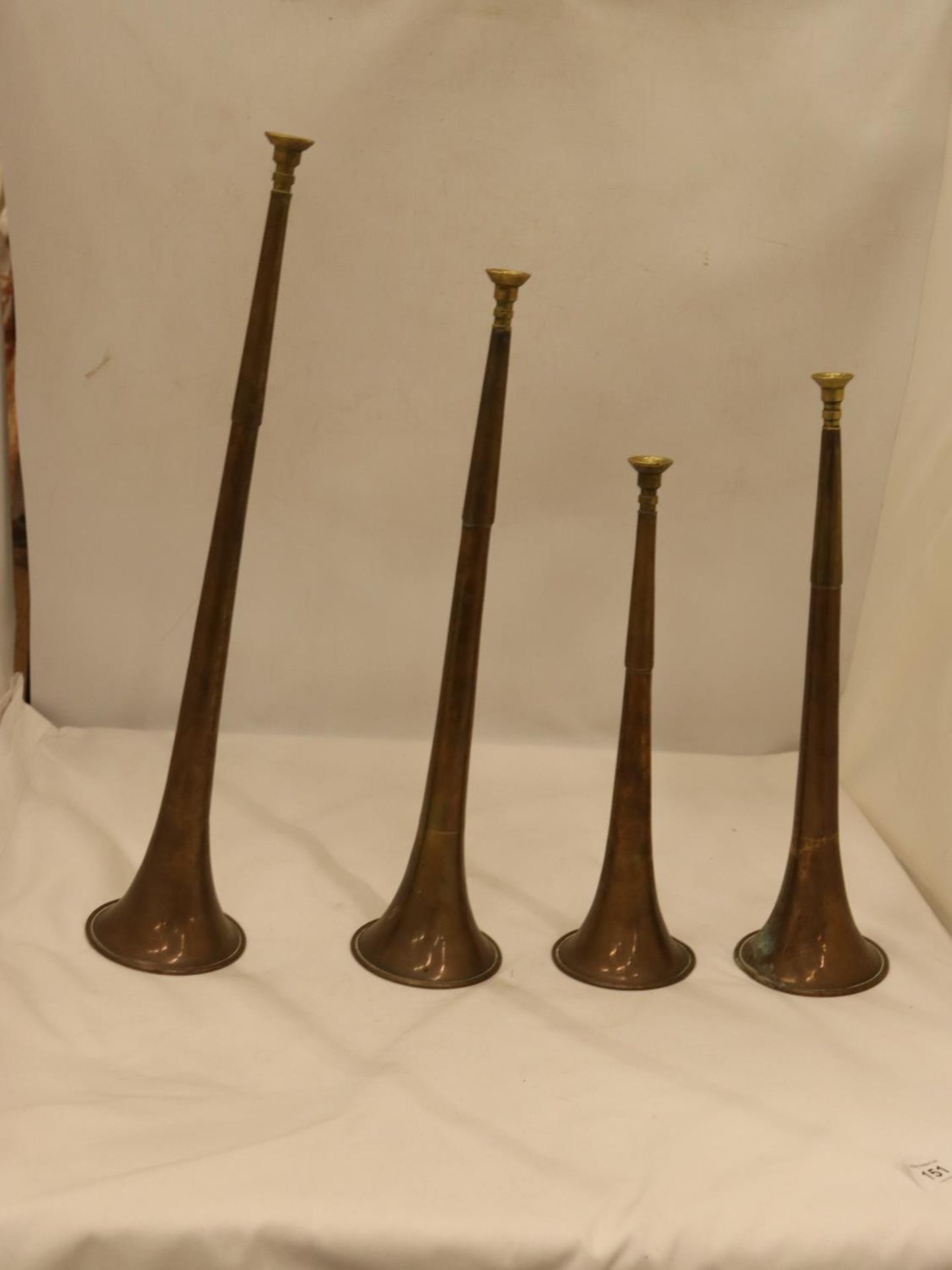 FOUR GRADUATED VICTORIAN BRASS AND COPPER HUNTING HORNS