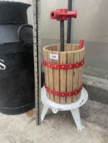 A SMALL WOODEN AND METAL APPLE PRESS