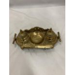 AN ORNATE VINTAGE BRASS INKWELL STAND