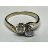 A 9 CARAT GOLD RING WITH TWO CUBIC ZIRCONIAS ON A TWIST DESIGN SIZE J
