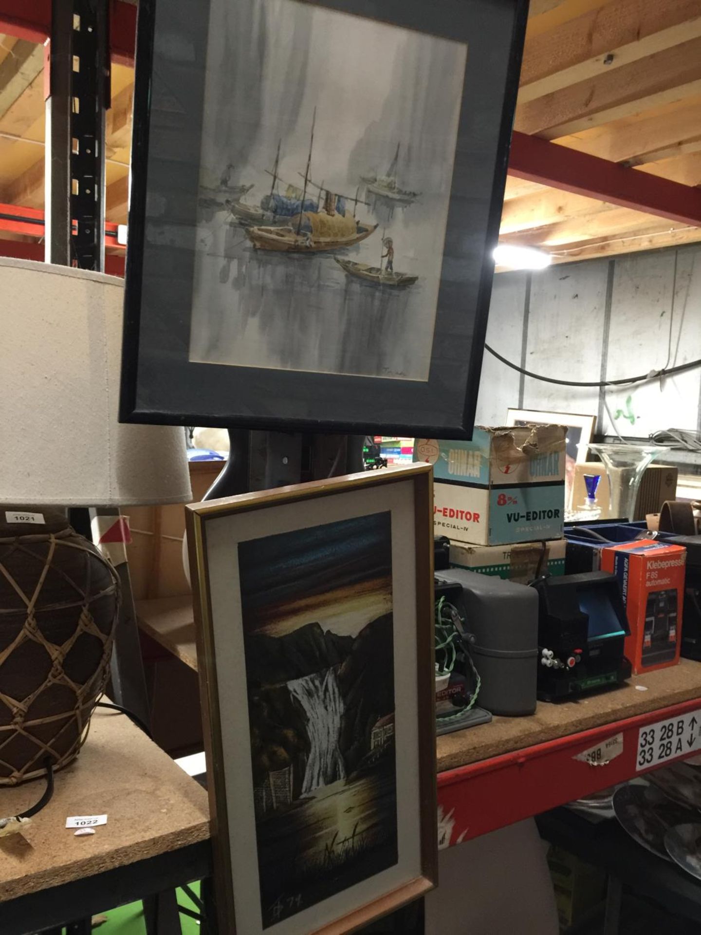 TWO FRAMED PRINTS ONE OF A WATERFALL AND AN ORIENTAL OF BOATS