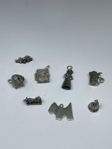 EIGHT SILVER CHARMS