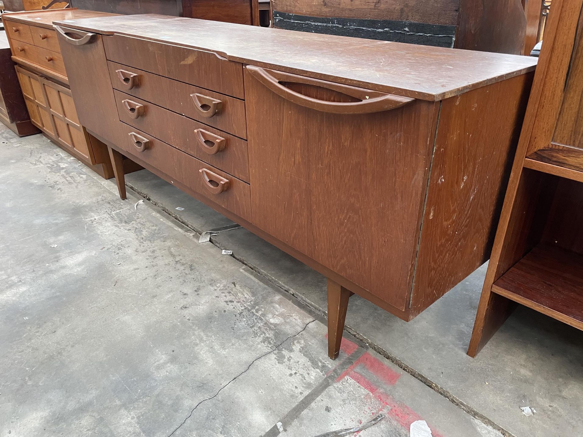 A RETRO TEAK BEAUTILITY SIDEBOARD ENCLOSING FOUR DRAWERS AND TWO CUPBOARDS, 72" WIDE - Image 2 of 3