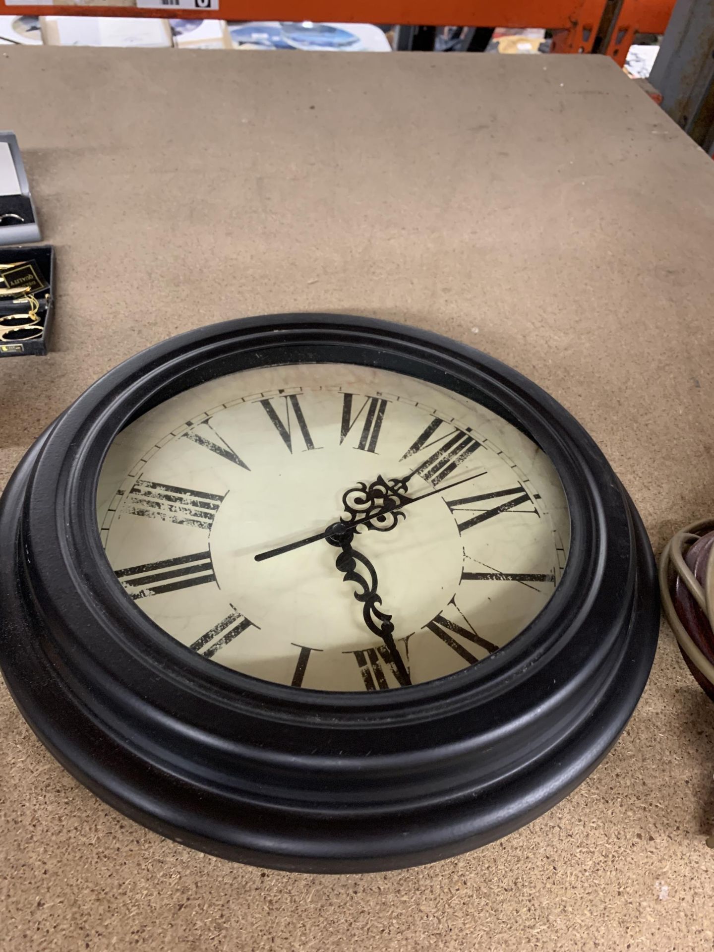 A MODERN STYLE CLOCK WITH ROMAN NUMERALS