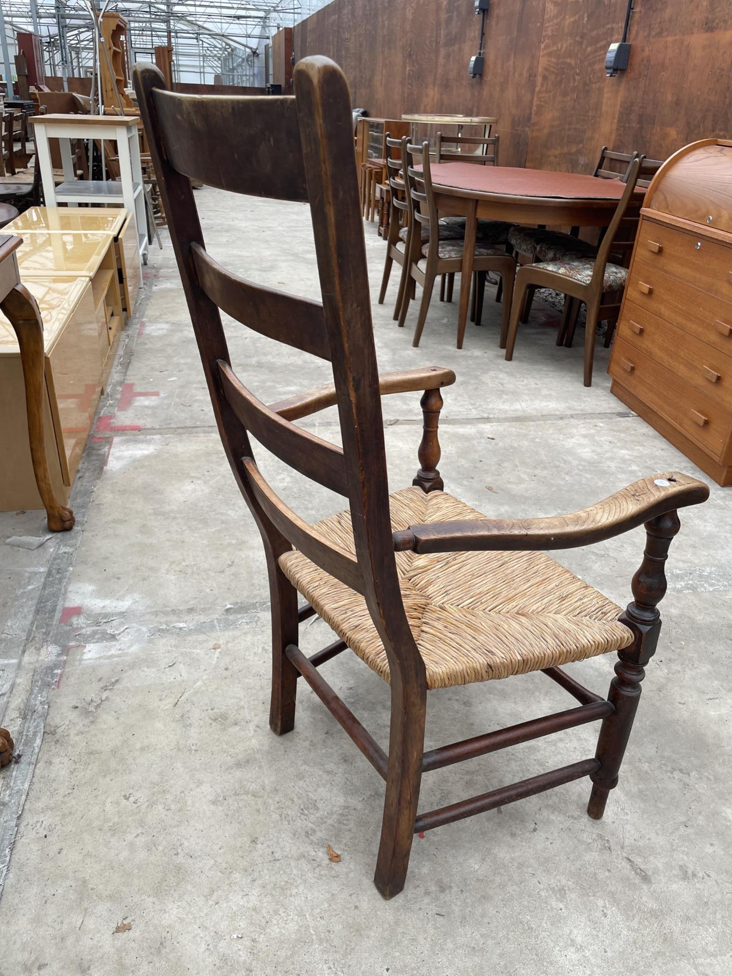A 19TH CENTURY LADDERBACK ELBOW CHAIR WITH RUSH SEAT - Image 4 of 4