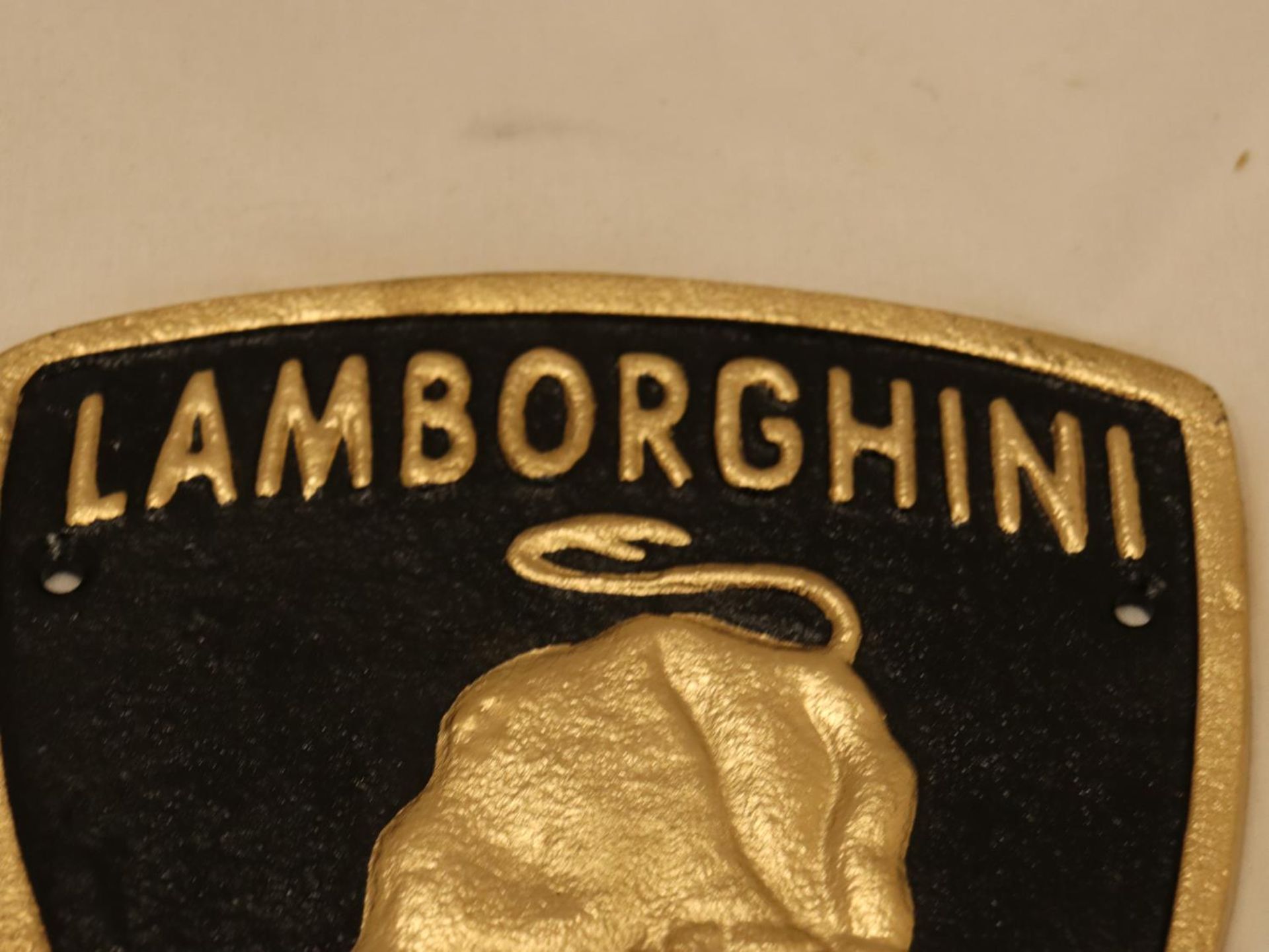 A TRIANGULAR BLACK AND GOLD CAST METAL LAMBORGHINI SIGN, 21CM X 18CM - Image 2 of 3