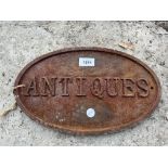 A VINTAGE CAST 'ANTIQUES' SIGN