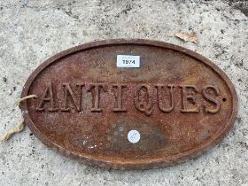 A VINTAGE CAST 'ANTIQUES' SIGN