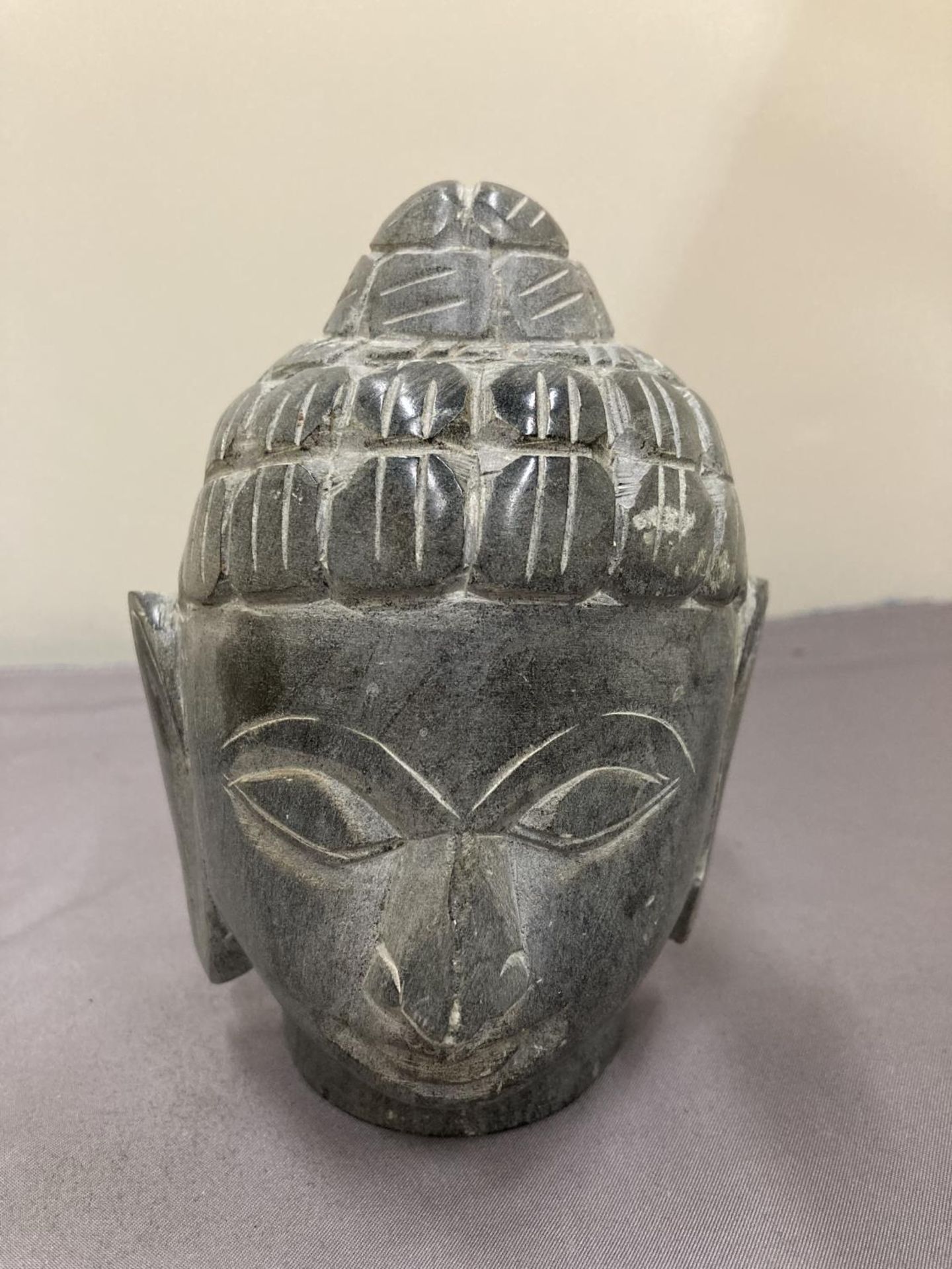 A GREEN STONE HEAD BUDDAH