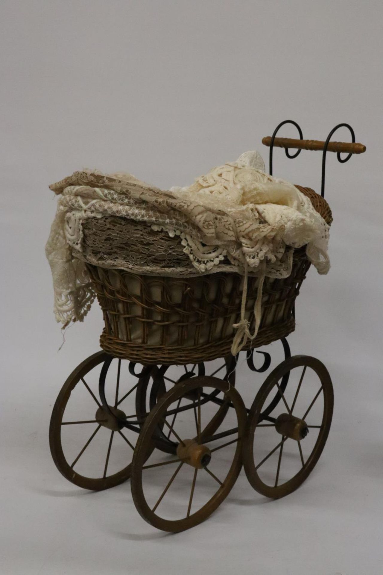 A VICTORIAN CHILD'S PRAM WITH LACE COVERS