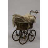 A VICTORIAN CHILD'S PRAM WITH LACE COVERS
