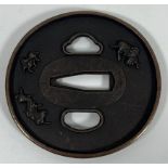 A JAPANESE BRONZE TSUBA WITH MYTHICAL BEAST DESIGN, DIAMETER 7.5 CM