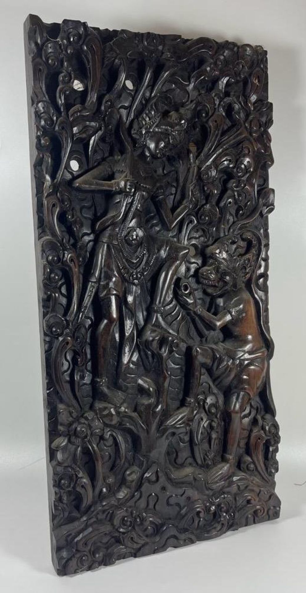 A VINTAGE CHINESE HEAVILY CARVED WOODEN PLAQUE DEPICTING A FIGURE WITH MYTHICAL BEAST, 45 X 22CM