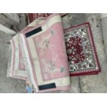 A PINK PATTERNED FRINGED RUG AND A SMALL RED PATTERNED RUG