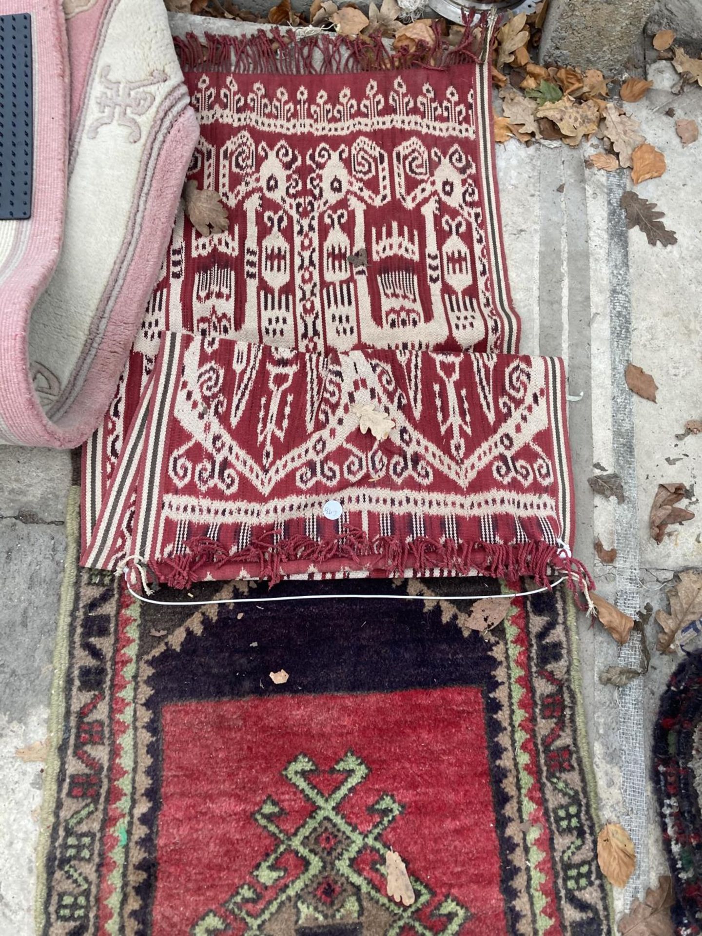 A SMALL RED PATTERNED FRINGED RUG AND A SMALL RED PATTERNED WALL HANGING - Bild 3 aus 3