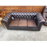 A BROWN LEATHER THREE SEATER CHESTERFIELD SETTEE