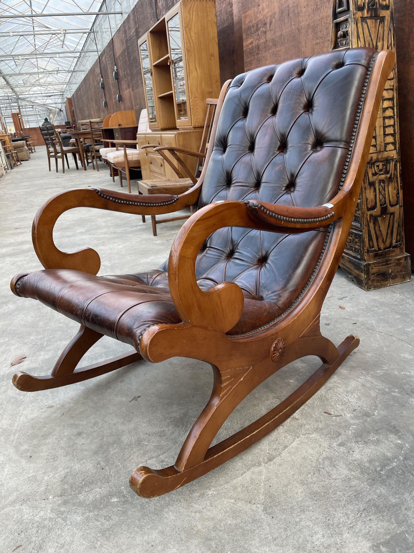 A MODERN SLIPPER LEATHER BUTTON-BACK ROCKING CHAIR