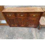 A VICTORIAN PINE DRESSER BASE ENCLOSING THREE DRAWERS AND THREE CUPBOARDS, 59" WIDE