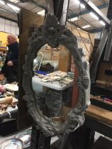 A CARVED FRAME MIRROR