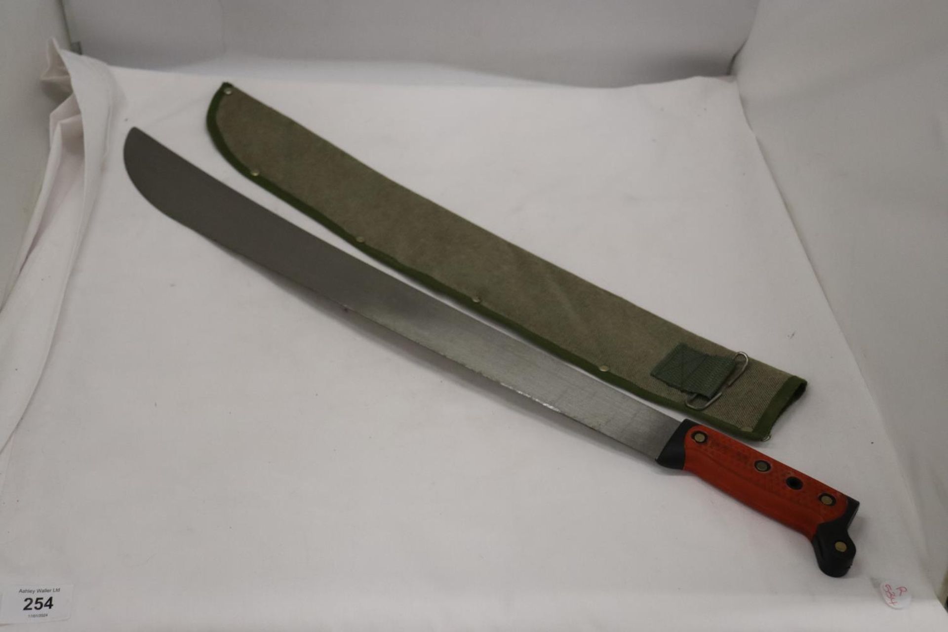 A MACHETE IN A CLOTH SHEATH