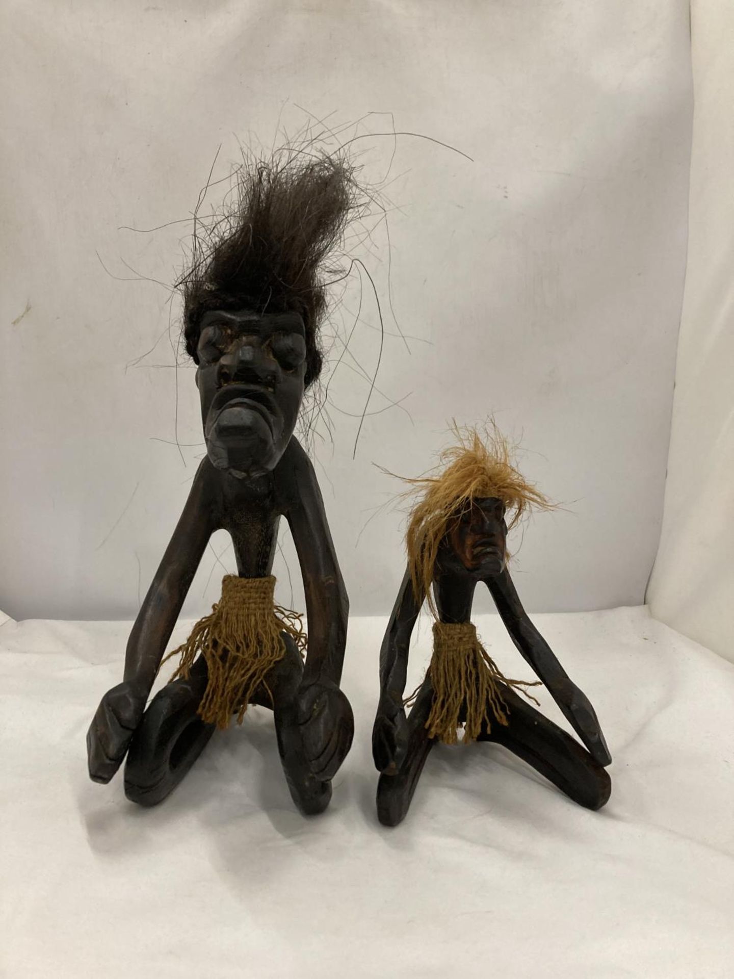 TWO GROTESQUE ETHNIC KNEELING FIGURES