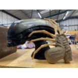 A LARGE ALIEN HEAD AND CLAW CELEBRATING ALIEN 25TH ANNIVERSARY