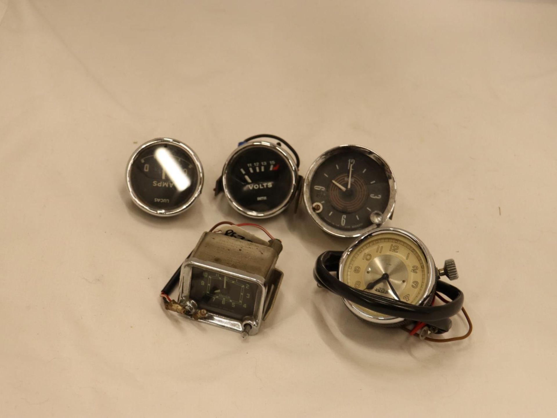 FIVE VINTAGE CAR CLOCKS/GAUGES