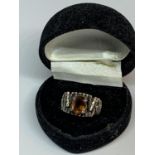 A SILVER AND AMBER COLOURED STONE RING IN A PRESENTATION BOX