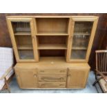 AN ERCOL BLONDE WINDSOR DRESSER WITH PARTLY GLAZED UPPER PORTION, CUPBOARDS AND DRAWERS TO THE BASE,