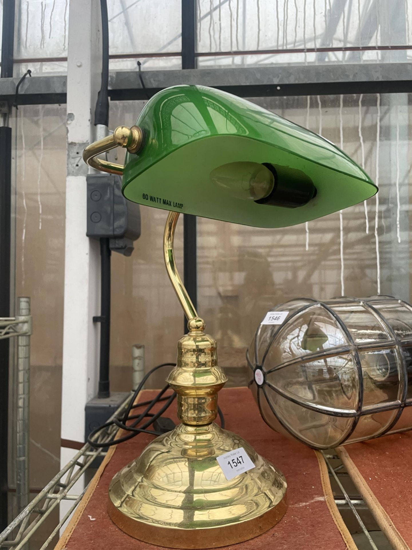 A BRASS BANKERS LAMP WITH GREEN GLASS SHADE