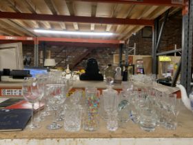 A LARGE QUANTITY OF GLASSWARE TO INCLUDE DRINKING GLASSES, DECANTER AND A BIRD FIGURE