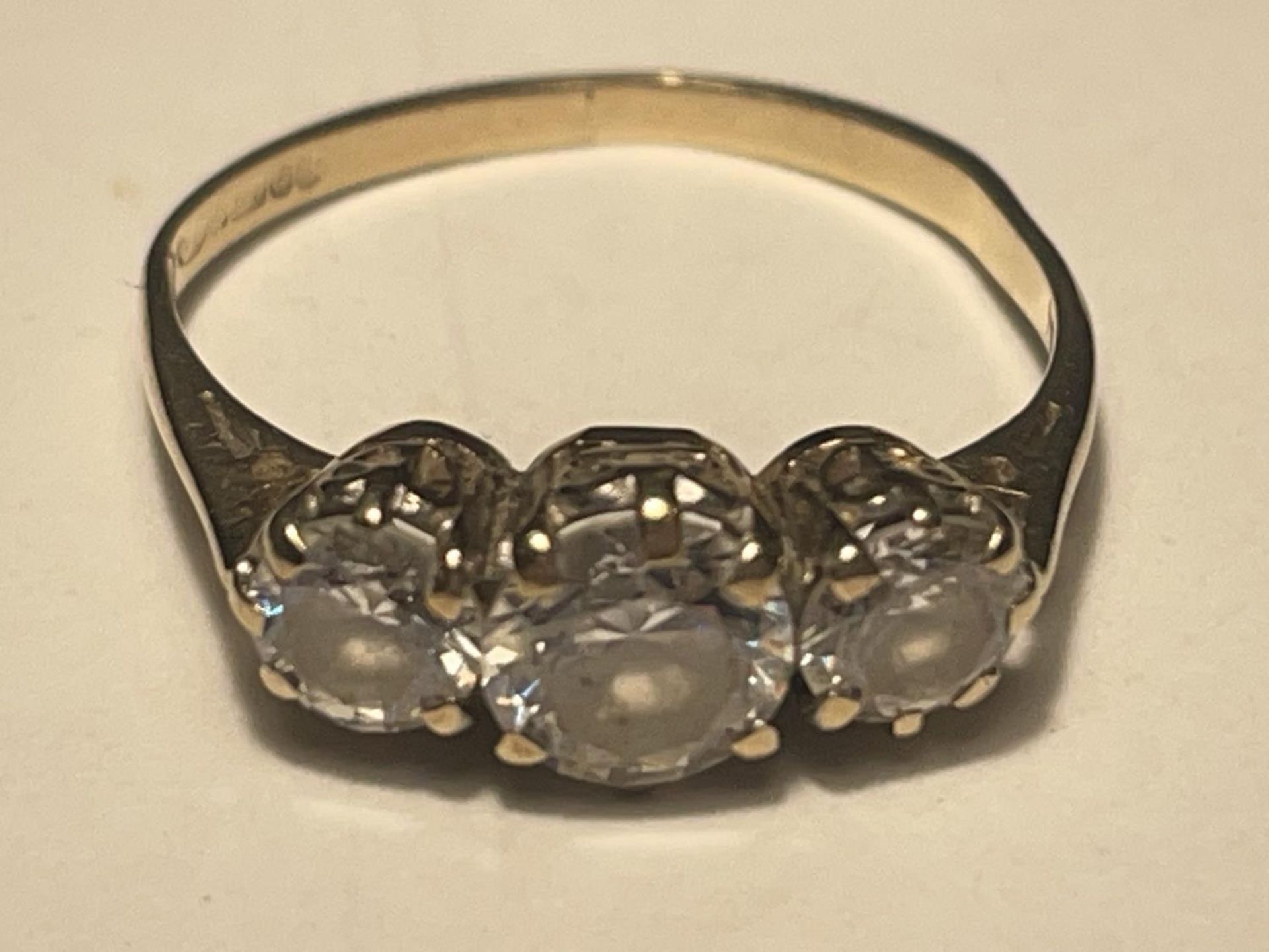 A 9 CARAT GOLD RING WITH THREE IN LINE CUBIC ZIRCONIAS