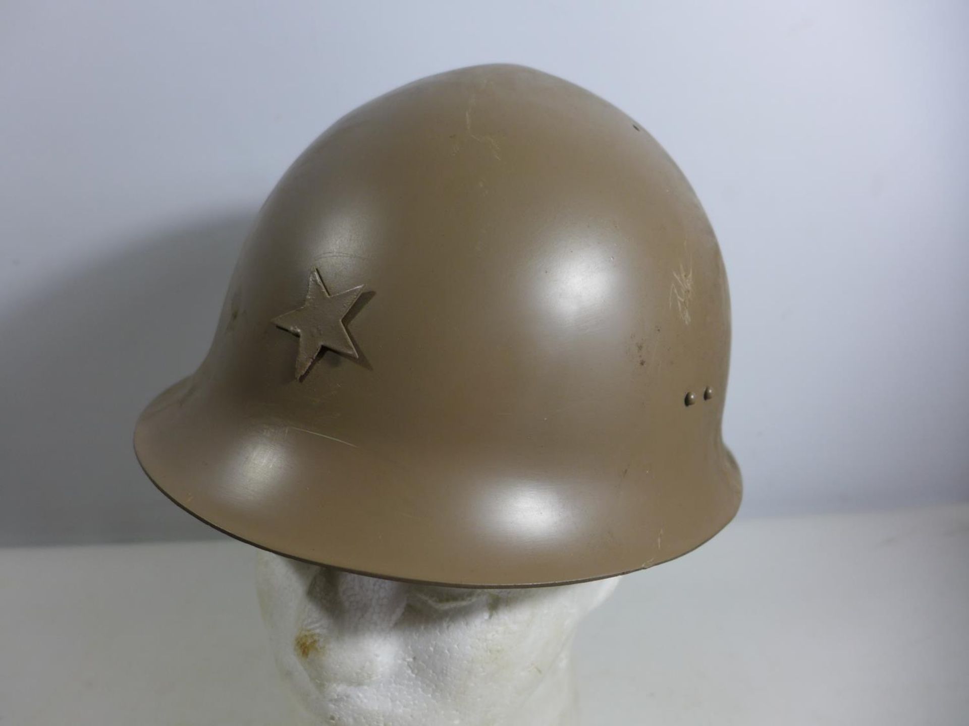 A PAINTED METAL MILITARY HELMET AND LINING