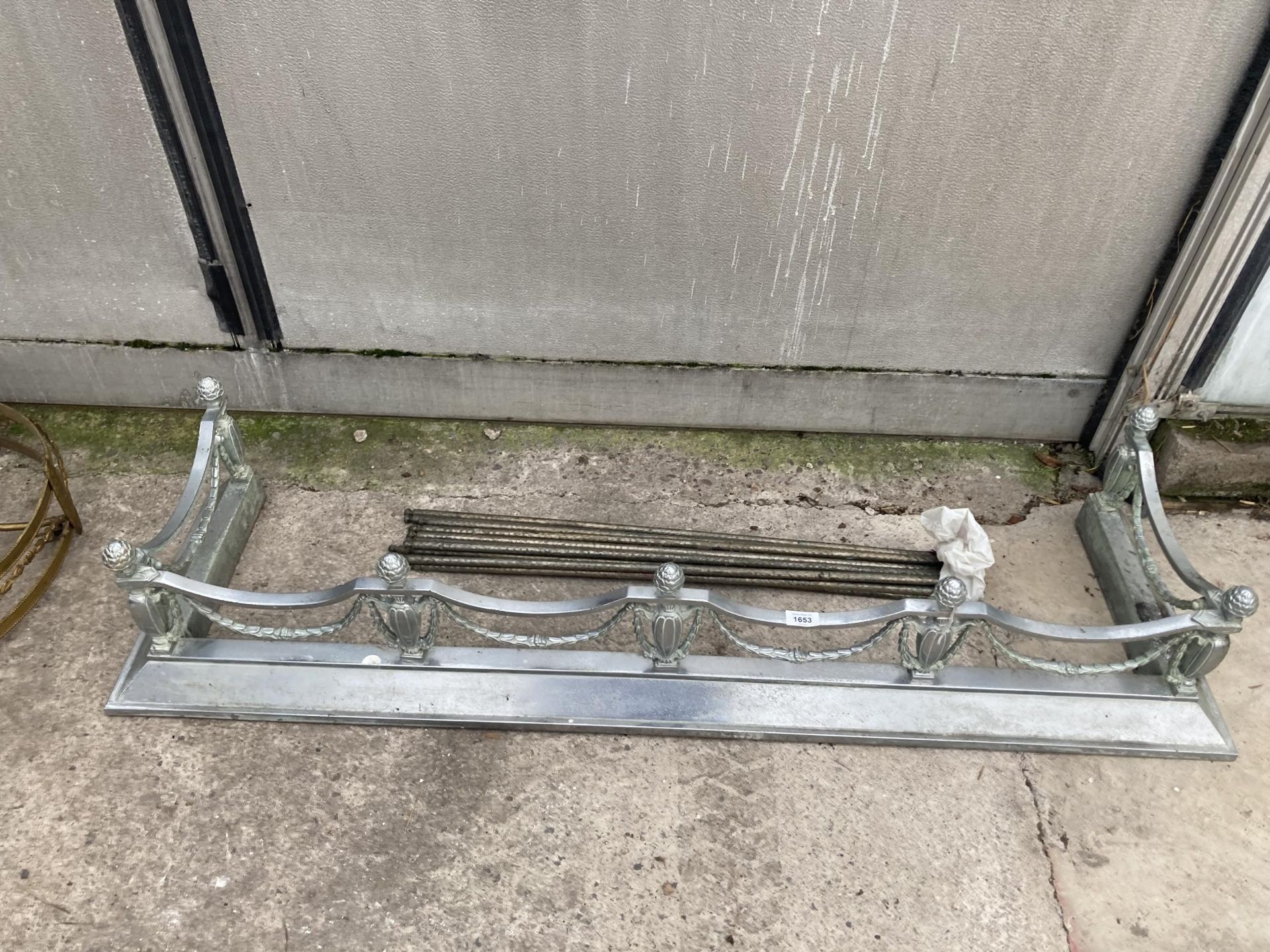 A VINTAGE METAL FIRE FENDER AND STAIR RODS WITH BRACKETS MARKED 'H&H'